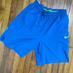 Blue Nike basketball shorts with lime green accents XL